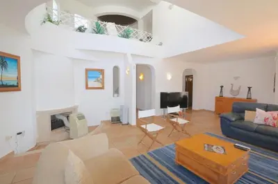 a living room with a couch and a table at Traditional Portuguese Villa 5 Bedrooms Villa Girassol Prime Location in Quarteira
