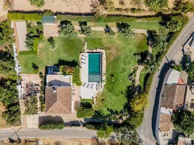 a swimming pool with a pergola next to a house at Charmante villa Authentique in Loulé