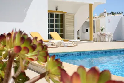 a villa with a swimming pool and a house at Villa Da Duarte - walkable to beach shops bars in Albufeira