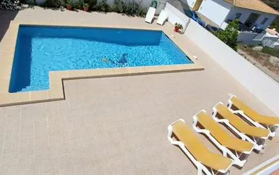 an overhead view of a swimming pool with chairs at Villa Da Duarte - walkable to beach shops bars in Albufeira