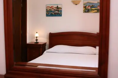 a mirror reflection of a bed in a bedroom at Villa Da Duarte - walkable to beach shops bars in Albufeira