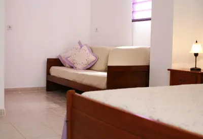 a room with a couch with two pillows on it at Villa Da Duarte - walkable to beach shops bars in Albufeira