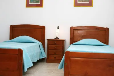 two beds sitting next to each other in a bedroom at Villa Da Duarte - walkable to beach shops bars in Albufeira