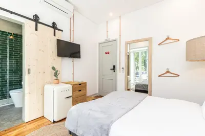 a bedroom with a bed and a tv on a wall at @ rita'splace in Faro