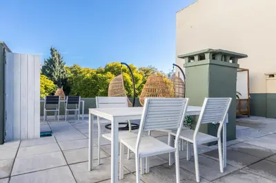 a white table and chairs on a patio at @ rita'splace in Faro