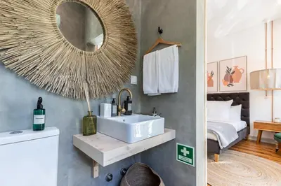 a bathroom with a sink and a mirror on the wall at @ rita'splace in Faro