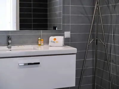 a bathroom with a white sink and a mirror at Harmony 4B House by Stay ici Algarve Holiday Rental in Albufeira