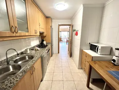 a kitchen with a sink and a microwave at Olivos del golf - Terrace with pool by HD in Vilamoura