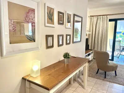a living room with a table and a chair at Olivos del golf - Terrace with pool by HD in Vilamoura