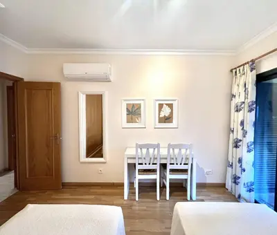 a dining room with a table and two chairs at Olivos del golf - Terrace with pool by HD in Vilamoura