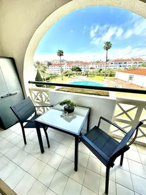 a balcony with two chairs and a table on a balcony at Apart 306 in Albufeira