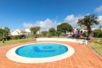a swimming pool in the middle of a yard at Apart 306 in Albufeira