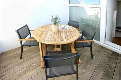 a dining room table with four chairs and a table at Zen & Tan Apartment in Faro