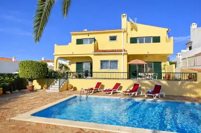 a villa with a swimming pool in front of a house at Margarida by Check-in Portugal in Albufeira