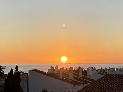 a view of the sunset from the roofs of buildings at Margarida by Check-in Portugal in Albufeira