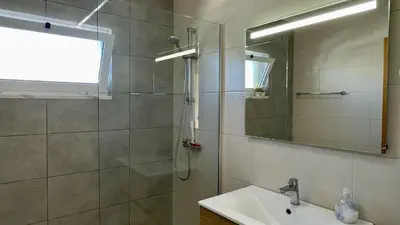 a bathroom with a shower and a sink and a mirror at Margarida by Check-in Portugal in Albufeira