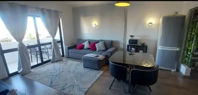 a living room with a couch and a table at Albufeira SPOT com piscinas exteriores e interior! in Albufeira