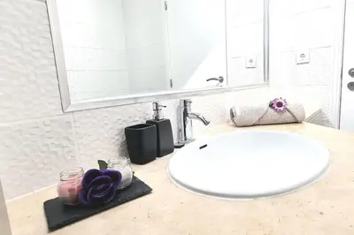 a bathroom counter with a sink and a mirror at Albufeira SPOT com piscinas exteriores e interior! in Albufeira