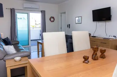 a living room with a table and a couch at Bay View Modern Apartment in Albufeira