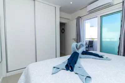 a bedroom with a bed with towels on it at Bay View Modern Apartment in Albufeira
