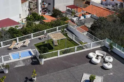 an overhead view of a patio with lounge chairs and tables at Bay View Modern Apartment in Albufeira