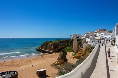 a view of a beach with the ocean and buildings at Bay View Modern Apartment in Albufeira