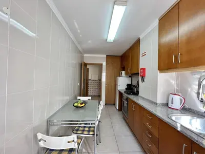 a kitchen with a table and chairs in a room at Albufeira Brightness by Homing in Albufeira