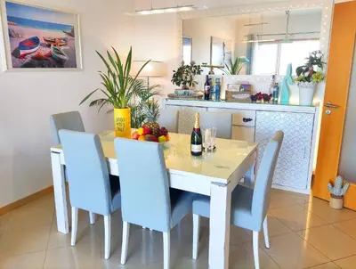 a kitchen with a table with chairs and a table and a table andktop at AlbufeiraOrada II by Be Cherish in Albufeira