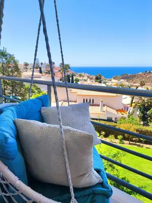a swing on a balcony with a view of the ocean at AlbufeiraOrada II by Be Cherish in Albufeira