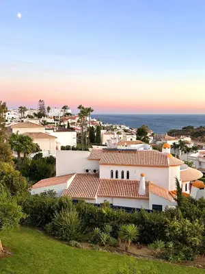 a view of a white house with the ocean in the background at AlbufeiraOrada II by Be Cherish in Albufeira