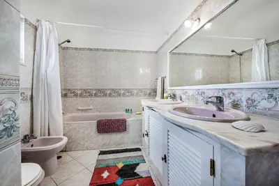a bathroom with a sink and a tub and a toilet at Villa Dois Pinheiros in Albufeira