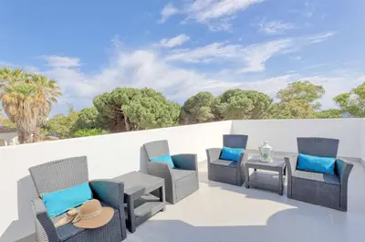 a group of chairs and a table on a patio at Villa Sequeira in Albufeira
