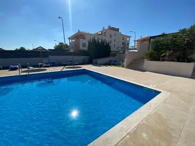 a large blue swimming pool on top of a house at Corcovada, Sunny and Bright T1 with Large Terrace, Albufeira in Albufeira