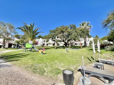 a park with a child playing in the grass at Albufeira Balaia Golf Vilage 1 With Pool by Homing in Albufeira