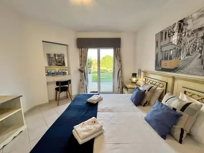 a large bed with blue pillows in a room at Albufeira Balaia Golf Vilage 1 With Pool by Homing in Albufeira