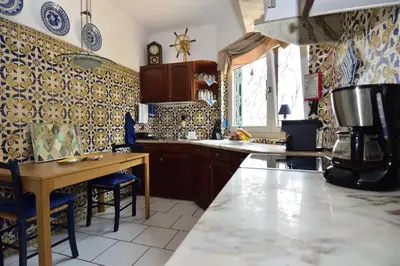 a kitchen with a counter and a table in it at Villa Casa Tulipa Sleeps 4 with Pool Garden & A c in Albufeira