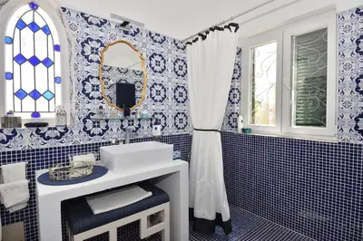 a blue and white bathroom with a sink and a mirror at Villa Casa Tulipa Sleeps 4 with Pool Garden & A c in Albufeira