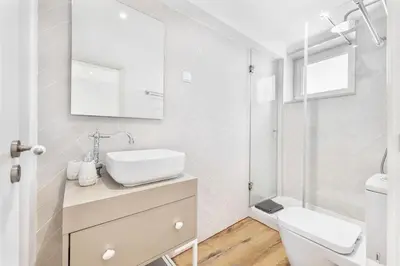 a white bathroom with a sink and a toilet at RG Casa do Carmo in Faro