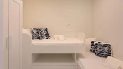 a white room with a bed with pillows on it at Keiko in Vale do Lobo