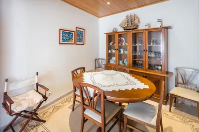 a dining room with a wooden table and chairs at Private 2 Bed Apartment in Albufeira Old Town in Albufeira