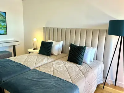 a bedroom with a large bed with pillows at One - Luxurious apartment by HD PROPERTIES in Vilamoura