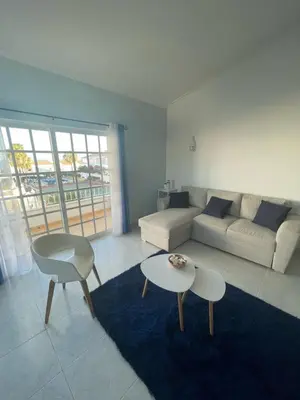 a living room with a couch and a table at casa Vela in Albufeira