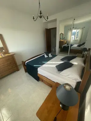 a bedroom with two beds and a mirror at casa Vela in Albufeira