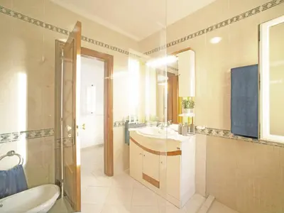 a bathroom with a sink and a toilet and a mirror at Villa Inês by Interhome in Galé
