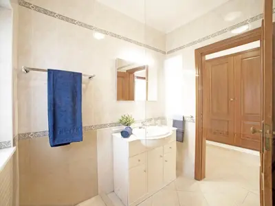 a bathroom with a sink and a blue towel at Villa Inês by Interhome in Galé