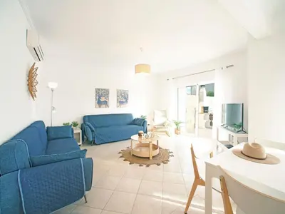 a living room with two blue couches and a table at Villa Inês by Interhome in Galé