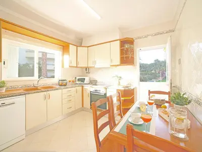a kitchen with a table with chairs and a dining room at Villa Inês by Interhome in Galé