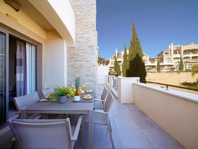 a dining table and chairs on a patio at Apartment Pine Hills Esmeralda by Interhome in Vilamoura