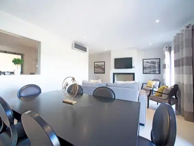 a kitchen with white cabinets and a large window at Apartment Pine Hills Esmeralda by Interhome in Vilamoura
