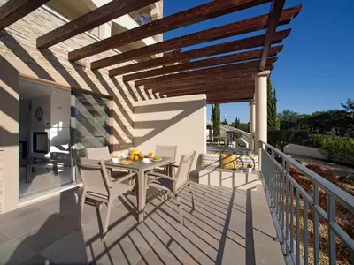 a walkway with trees and a fence next to a building at Apartment Pine Hills Rubi by Interhome in Vilamoura